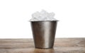 Metal bucket with ice cubes on table against white background Royalty Free Stock Photo