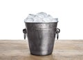 Metal bucket with ice cubes on table against white background Royalty Free Stock Photo