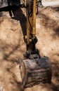 metal bucket teeth of backhoe digging soil