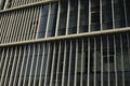 Metal building texture. Narrow windows in wall. Details of modern architecture