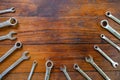 Metal bunch wrench tools lying on dark wooden background