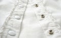 Metal buttons on white shirt close up