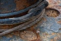 A metal cable tied around a rusty bitt Royalty Free Stock Photo