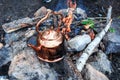 Metal camp kettle hanging over the campfire