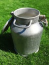 Metal can for liquids with an open lid. in sunny weather on the grass. the idea of a healthy diet. close-up. Royalty Free Stock Photo