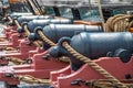 Metal canons on the side of an old war ship Royalty Free Stock Photo
