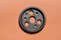 Metal cogwheel on pink background