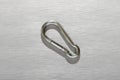 Metal carabiner on gray background