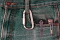 Metal carabiner and tools on the jeans. everyday tools