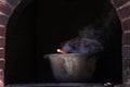 Metal cauldron slowly cooking