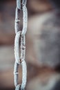 Metal chain covered with white hoarfrost on an old wooden wall background Royalty Free Stock Photo