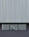 Metal sheet  ,  Gray Wall and Glass Windows With the design of installing modern building structure Royalty Free Stock Photo