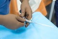 Metal children`s cystoscope in the hands of a urologist