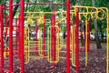 Metal children`s outdoor playground equipment bars swing yellow and red color