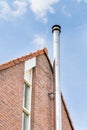 Metal chimney pipe on facade of house