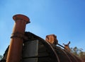 METAL CHIMNEY PIPE ON WOODEN CHAMBER OF A DILAPIDATED 1933 THRESH DISINFECTOR