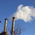 Metal chimneys of boiler house and smoke out of them