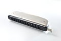 Metal chromatic harmonica isolated on white table elevated view Royalty Free Stock Photo