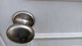 Metal chrome handle on white wooden door Royalty Free Stock Photo