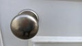 Metal chrome handle on white wooden door Royalty Free Stock Photo