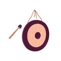 Metal circle gong and hammer for playing. Asian percussion musical instrument with mallet. Round music disc suspended on