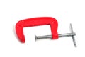 Metal clamp red on a white background isolate Royalty Free Stock Photo