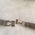 Metal clasp on Gucci swimsuit with logo