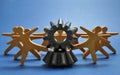 Metal cogs cogwheels and wooden figures of people