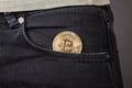 metal coin bitcoin in the front pocket of jeans close-up