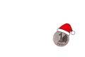 Metal coin, denomination, one Lari Georgia in a Santa Claus hat. White isolated background Royalty Free Stock Photo