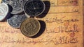 Coins of dinars, Kuwait national currency and lines from the Quran Royalty Free Stock Photo