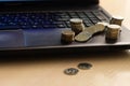 metal coins lie on the laptop& x27;s keyboard