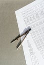 A metal compass lies on papers on which tables with many calculations and numbers are printed. Royalty Free Stock Photo