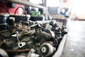 Metal components on workbench in auto repair shop. Mechanics repairing, maintaining car in garage, Royalty Free Stock Photo