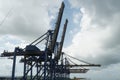 Metal construction of blue big gantry cranes in horizontal position awaiting cargo operation of the container ships. Royalty Free Stock Photo