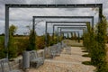 From metal constructions to climbing plants and vines is a sitting terrace of rough stone paving chipped cubes. metal gray furnitu Royalty Free Stock Photo