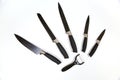 Metal cooking peeler knives with antibacterial coating black handle on white background. Kitchen utensils, edged weapons