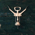 Metal corkscrew for on dark wood surface Royalty Free Stock Photo