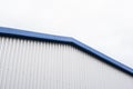 Metal corrugated sheets on a building with a blue metal corners. White aluminium metal corrugated roof or wall sheets Royalty Free Stock Photo