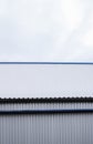 Metal corrugated sheets on a building with a blue metal corners. White aluminium metal corrugated roof or wall sheets Royalty Free Stock Photo