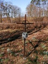 Metal cross standing near the road remembering the dead people