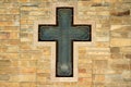 Metal cross on textured wall Royalty Free Stock Photo