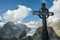 Metal cross on top of Eggishorn peak in Swiss Alps Royalty Free Stock Photo