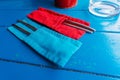 Metal cutlery in fabric covers of red and blue color. Royalty Free Stock Photo