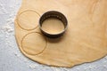Metal cutter cutting out circles of pastry for jam tarts