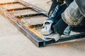 Metal cutting with an electric circular saw. Sparks fly in different directions. Blurred focus Royalty Free Stock Photo