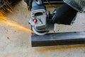 Metal cutting with an electric circular saw. Sparks fly in different directions. Blurred focus Royalty Free Stock Photo