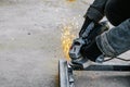 Metal cutting with an electric circular saw. Sparks fly in different directions. Blurred focus Royalty Free Stock Photo