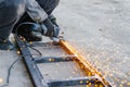 Metal cutting with an electric circular saw. Sparks fly in different directions. Blurred focus Royalty Free Stock Photo