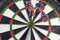 Metal darts have hit the red bullseye on a dart board. Darts Gam Royalty Free Stock Photo